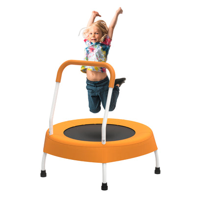 Child jumping on a small orange trampoline with a white background