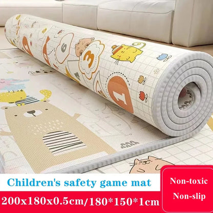 Children's safety game mat with cartoon designs, rolled up on a wooden floor.