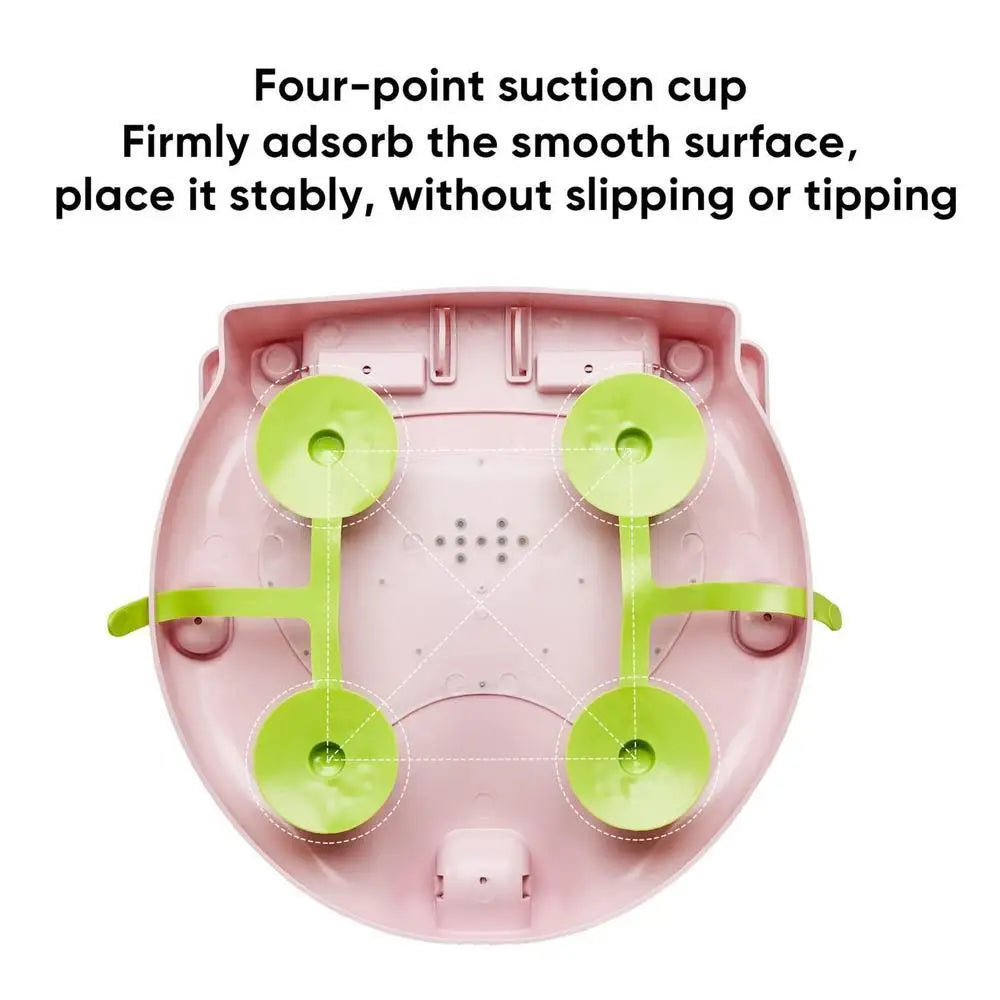 Pink electronic device with green suction cups on a white background