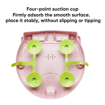 Pink electronic device with green suction cups on a white background
