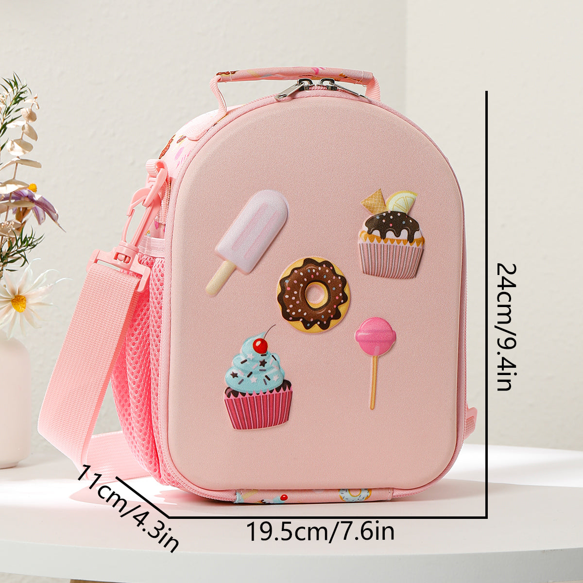 Pink lunch bag with dessert-themed decorations and measurements on a white background